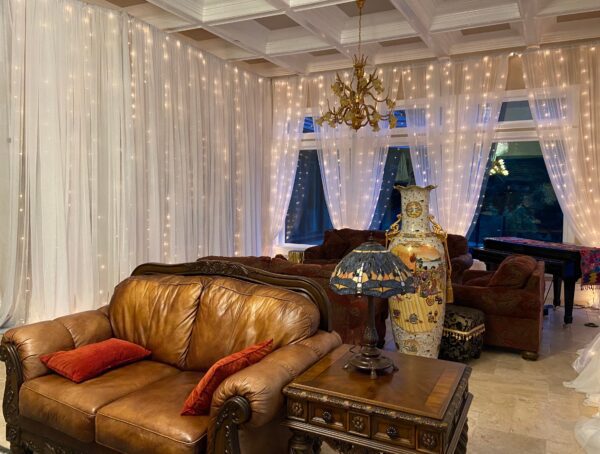 A living room with leather furniture and curtains.