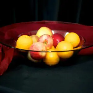 A bowl of fruit is sitting on the table.