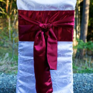 A chair with a red bow on it