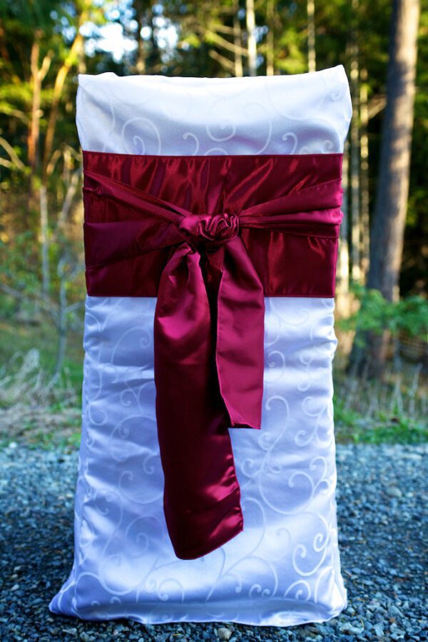 A chair with a red bow on it