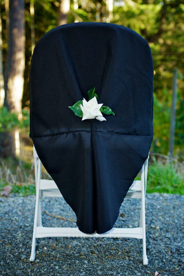 A black chair with white flowers on it