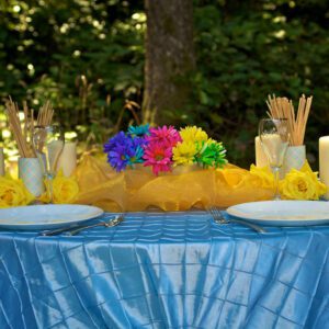 A table with two plates and flowers on it.