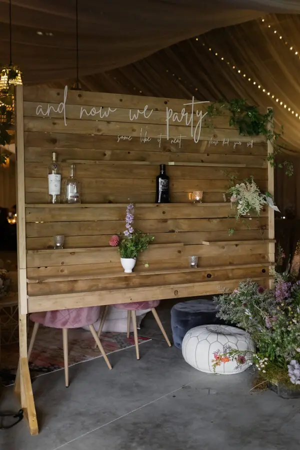 A wooden wall with plants and flowers on it