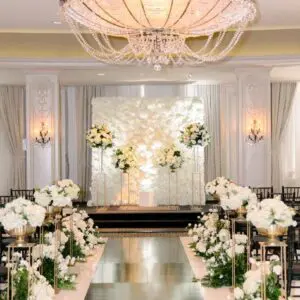 A wedding ceremony with white flowers and green leaves.