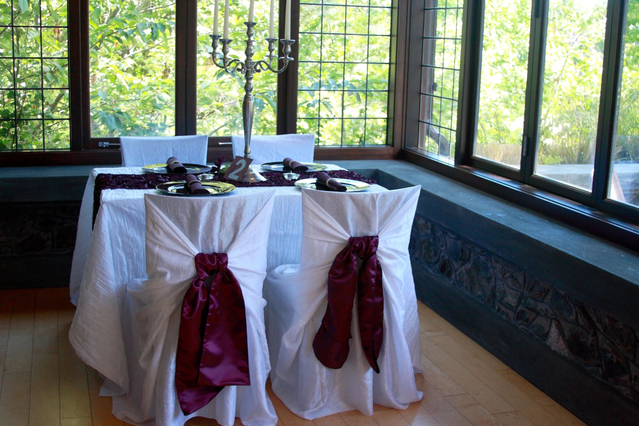 A table with two chairs and a candle holder