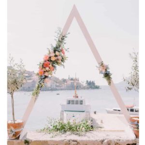 A white triangle with flowers on top of it.