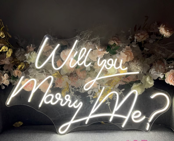 A neon sign that says " will you marry me ?"