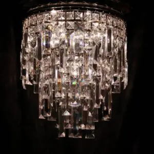 A chandelier with many glass pieces hanging from it.