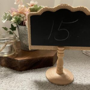 A chalkboard sign sitting on top of a table.