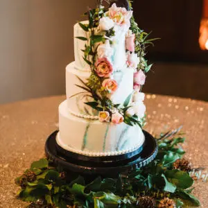 A three tiered cake with flowers on top of it.