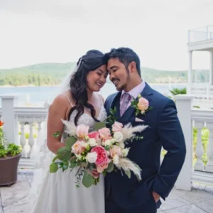 A bride and groom posing for a picture.