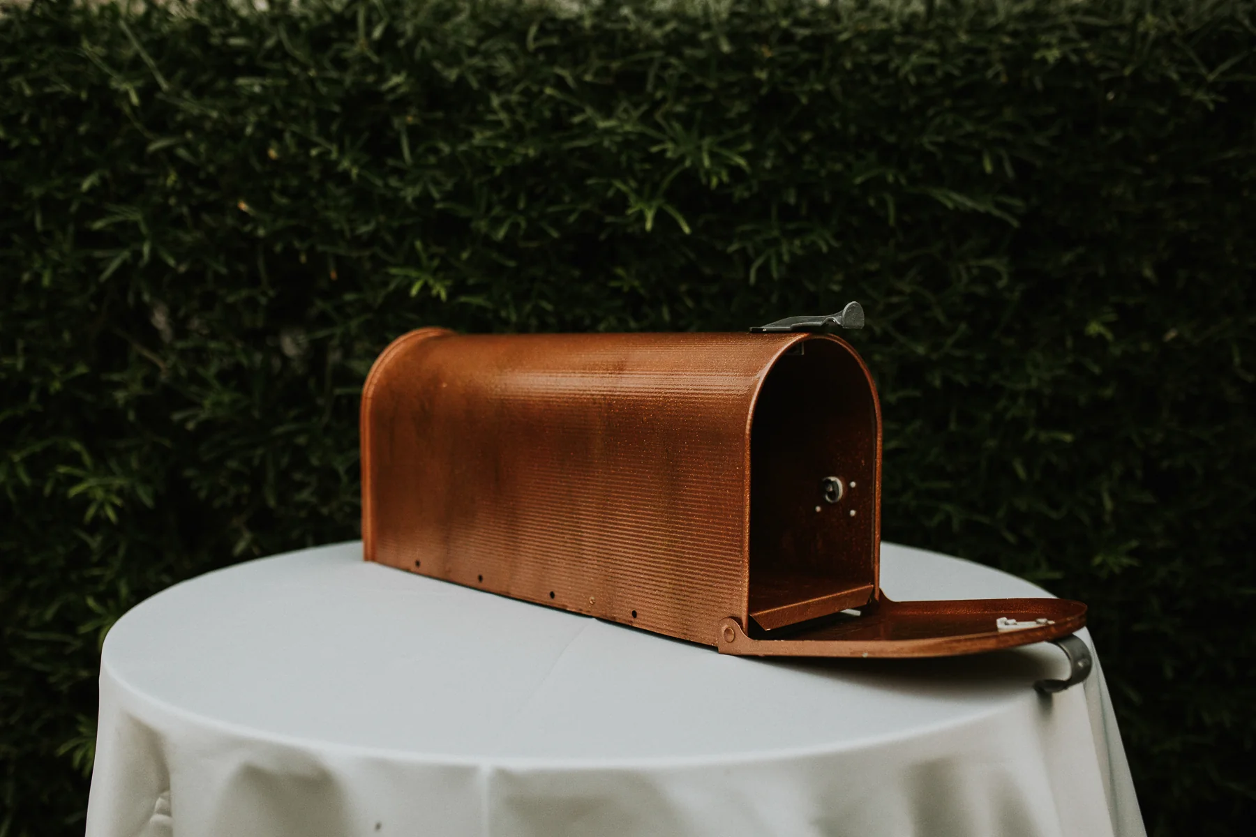 A brown mailbox sitting on top of a table.