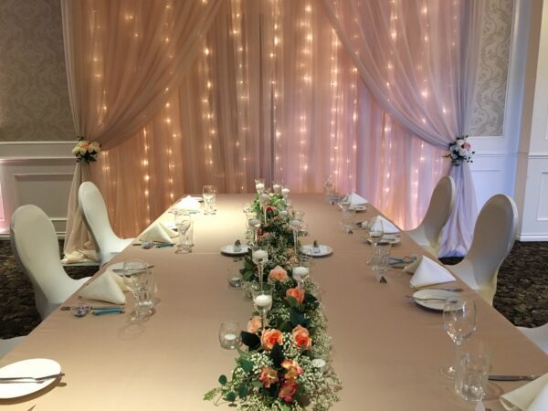 A table set up with flowers and candles.