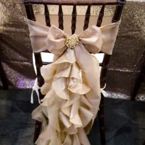 A chair with a bow and ruffles on it