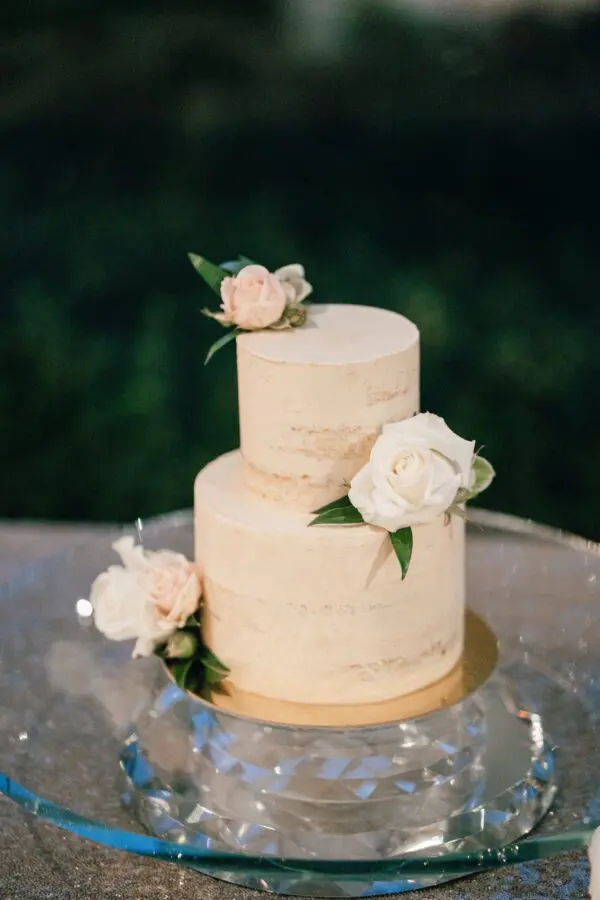 A two layer cake with flowers on top of it.