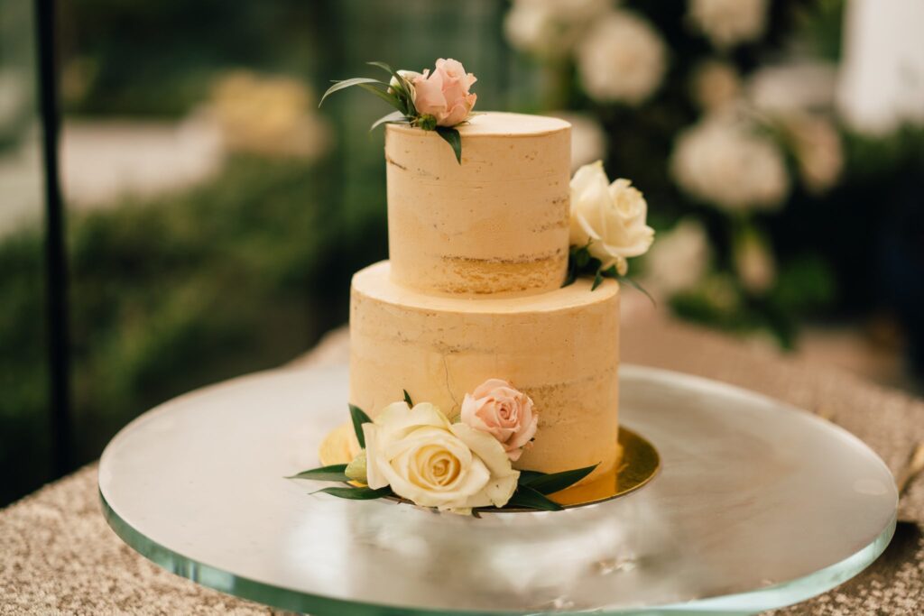 A two layer cake with flowers on top of it.