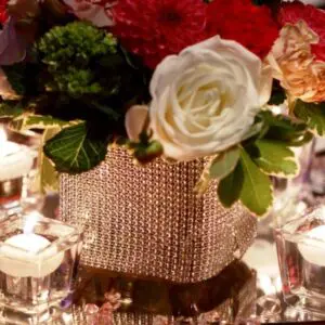 A close up of a vase with flowers on top