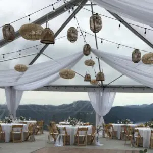 A tent with tables and chairs set up for an outdoor event.