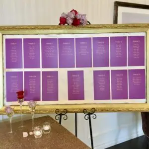 A table with a gold frame and purple seating chart.