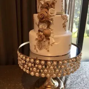 A cake on top of a gold stand.