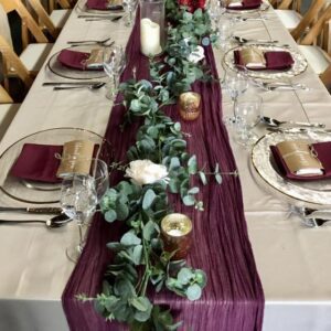 A table set with plates, candles and silverware.