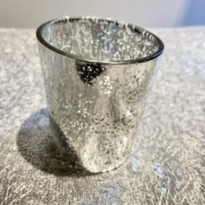 A glass cup sitting on top of a table.