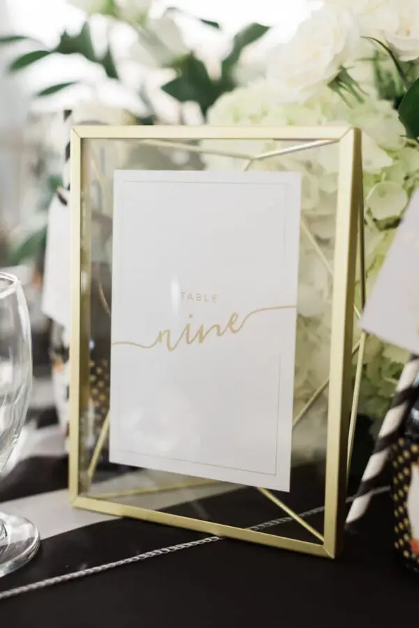 A table with a glass frame and some flowers