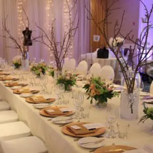 A long table with many plates and flowers on it