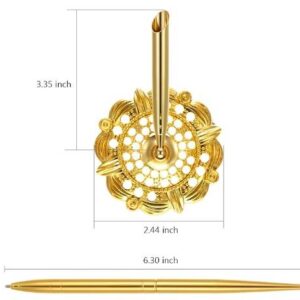 A gold plated metal hook with a flower design.