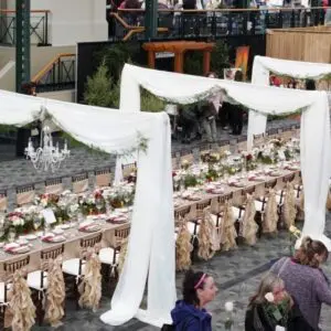 A long table with many chairs and tables of food