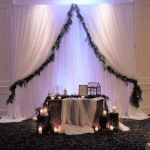 A wedding set up with candles and drapes