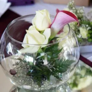 A vase with flowers inside of it on top of a table.