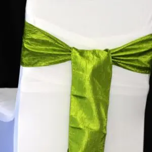 A white chair with green tie on it