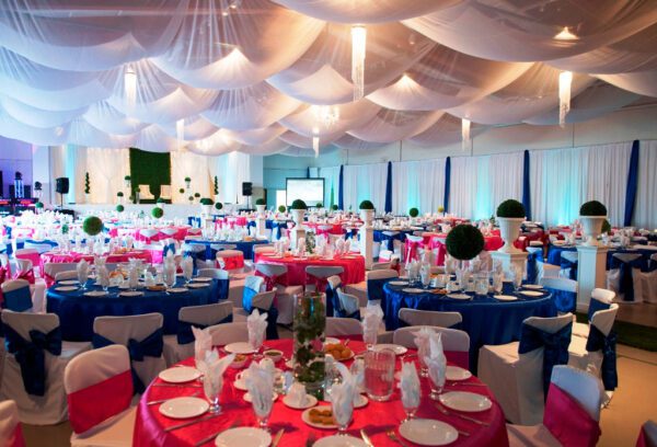 A banquet hall with tables and chairs set up for an event.