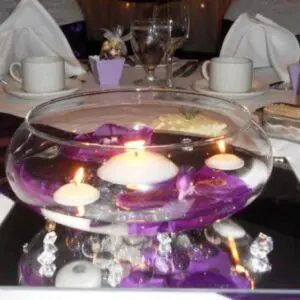 A bowl of water with candles in it