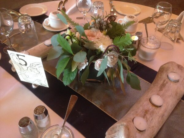 A table with flowers and candles on it