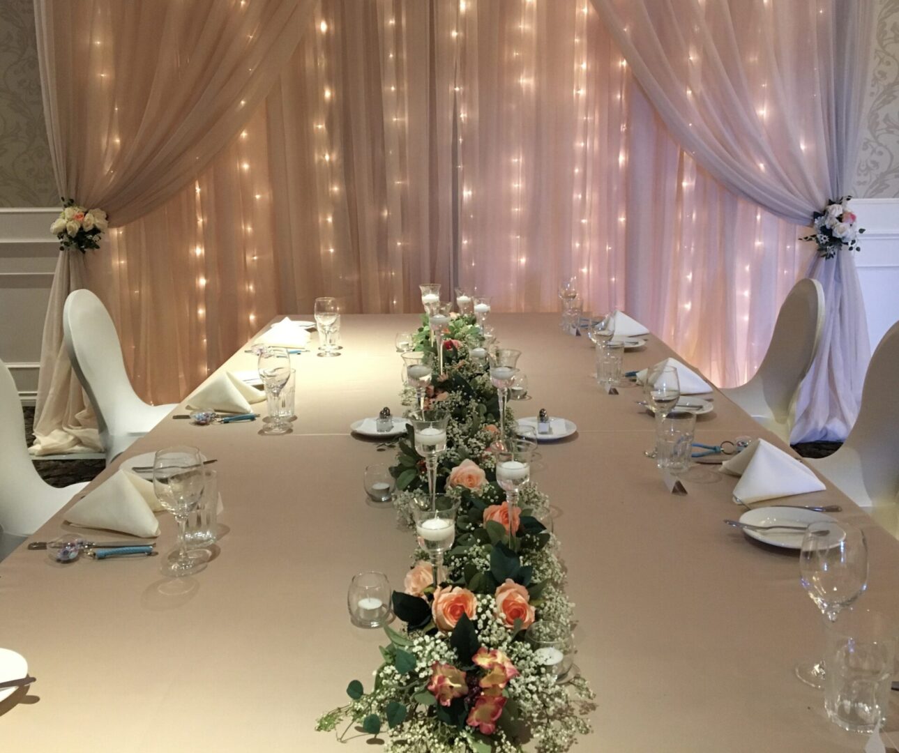 A table set up with flowers and candles.