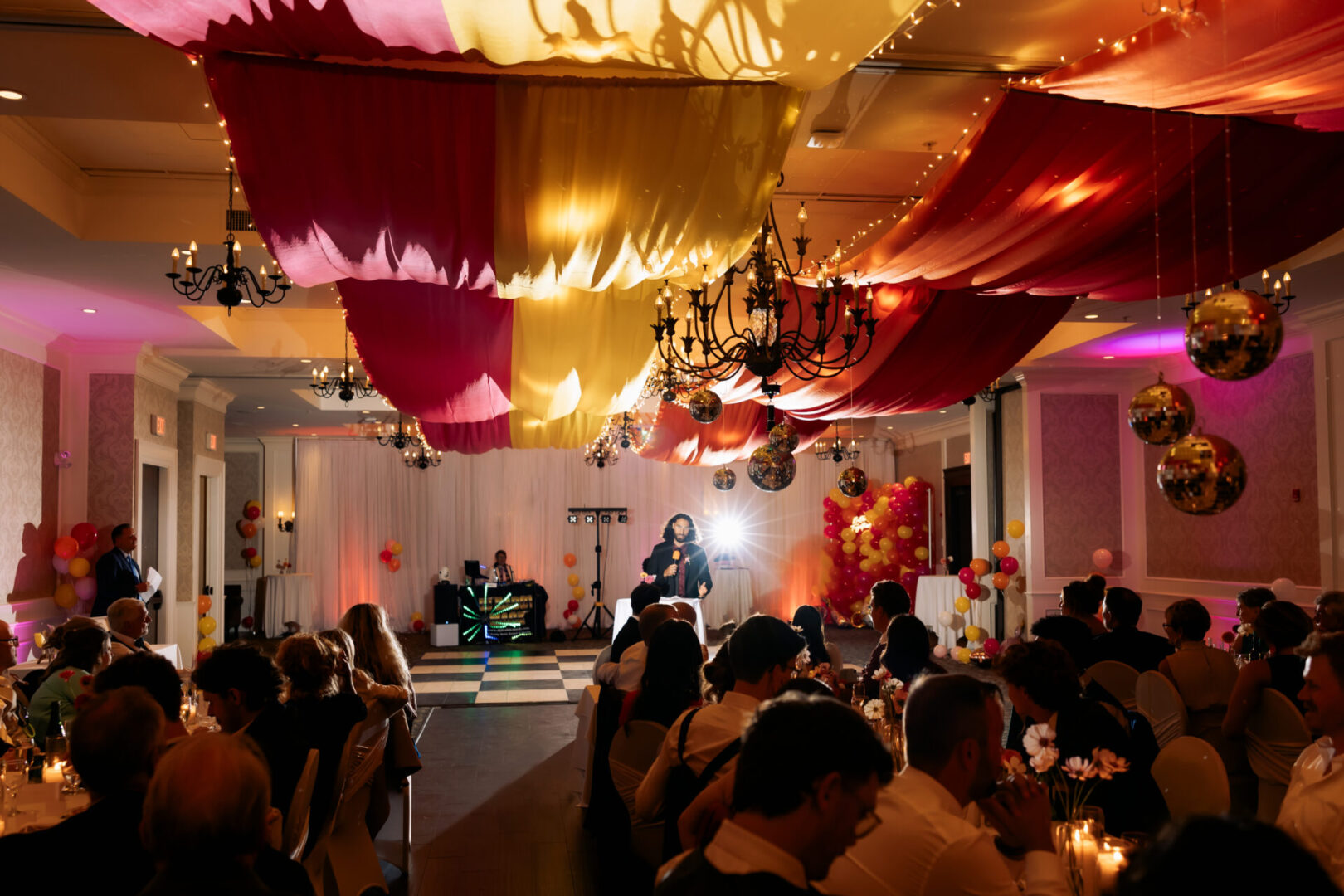 A group of people sitting at tables in a room.