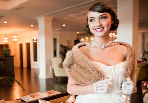 A woman in an old fashion dress posing for the camera.