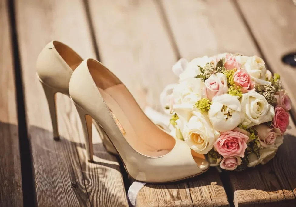 A close up of a pair of shoes with flowers